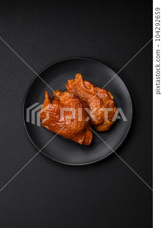Delicious fried or smoked chicken thighs grilled with spices and herbs 104292659