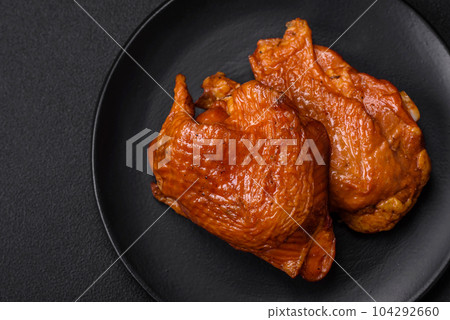 Delicious fried or smoked chicken thighs grilled with spices and herbs 104292660