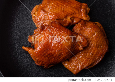 Delicious fried or smoked chicken thighs grilled with spices and herbs 104292685