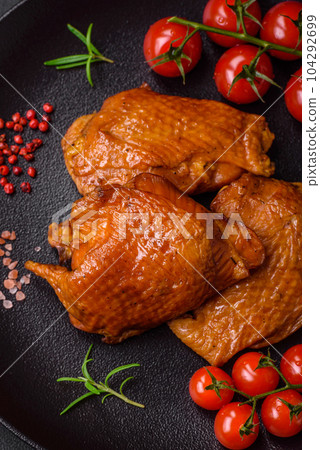 Delicious fried or smoked chicken thighs grilled with spices and herbs 104292699