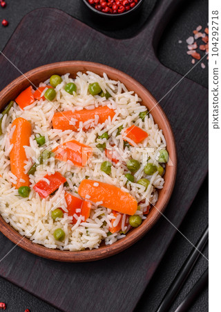 Delicious boiled rice with vegetables or risotto with salt, spices and herbs 104292718