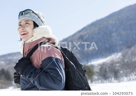 Young woman climbing a winter mountain 104293073