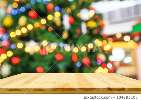 Empty wood table top with Abstract blur Christmas tree with decoration bokeh light background for product display 104293103