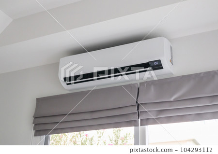 Air conditioner on white wall room interior background 104293112