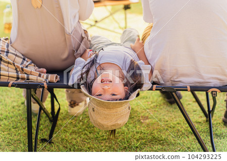 Family / Family sitting on a cot with a tarp at a campsite (Outdoor / Travel / Leisure / Picnic) Family / Family sitting on a cot with a tarp at a campsite (Outdoor / Travel / Leisure / Picnic) 104293225