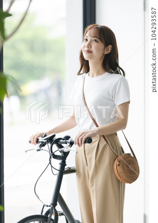 Woman going out by bicycle Woman going out by bicycle 104293587