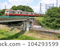Red electric 101 series on the Seibu Tamagawa Line crossing the Nogawa Bridge 104293599