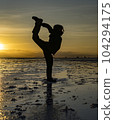 Sillouette of acrobat at sunrise on Bolivia Salt Flats 104294175