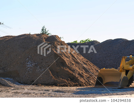 Stacked earth and bulldozer 104294838