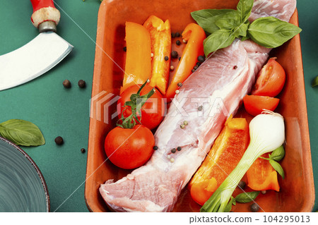 Raw pork tenderloin in a baking dish. Raw pork tenderloin in a baking dish. 104295013