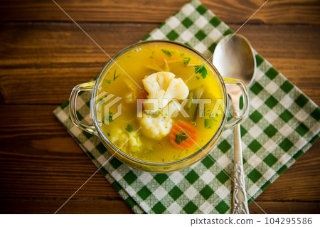 cooked chicken soup with cauliflower and vegetables in a bowl cooked chicken soup with cauliflower and vegetables in a bowl 104295586