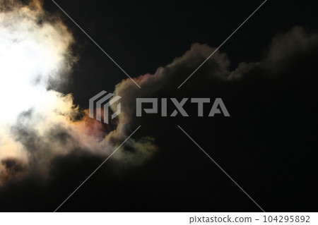Sun disk behind backlit clouds 104295892