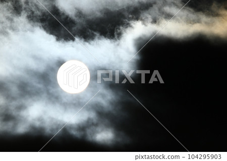 Sun disk behind backlit clouds Sun disk behind backlit clouds 104295903