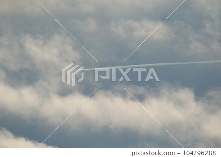 A plane and vapor trails in the sky A plane and vapor trails in the sky 104296288