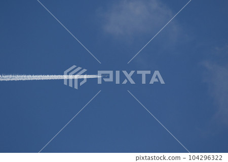 A plane and vapor trails in the sky 104296322