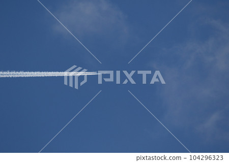 A plane and vapor trails in the sky A plane and vapor trails in the sky 104296323