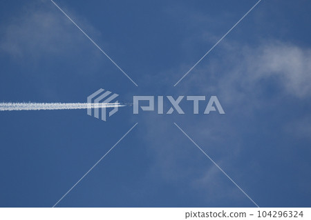 A plane and vapor trails in the sky A plane and vapor trails in the sky 104296324