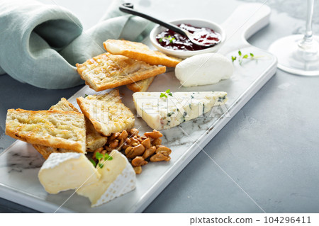 Small cheeseboard with baguette Small cheeseboard with baguette 104296411