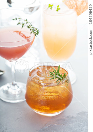 Variety of citrus cocktails on gray surface Variety of citrus cocktails on gray surface 104296439