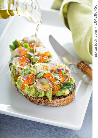Gourmet avocado toast with caviar and radishes Gourmet avocado toast with caviar and radishes 104296456