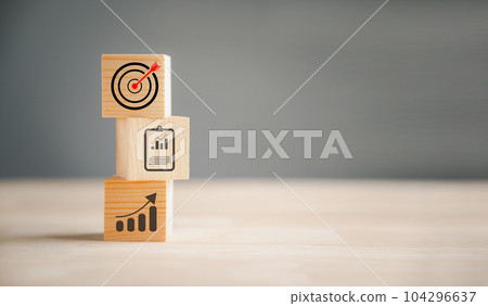 Cube wood blocks with Target icon on top, accompanied by rise up arrows. steps represent the vertical style of business growth process, emphasizing profit, investment, economic improvement concepts 104296637
