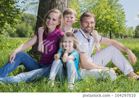 Family on grass in summer park 104297010