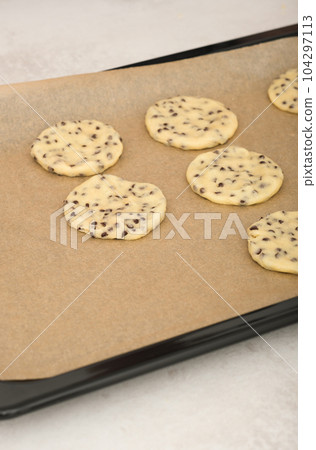 american classic chocolate chip cookies on a baking sheet ready to bake. home made raw cookies, pastry for dessert. american classic chocolate chip cookies on a baking sheet ready to bake. home made raw cookies, pastry for dessert. 104297113
