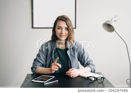 Young Businesswoman Conducting a Video Conference from Office or Home, Engaged and Confident Young Businesswoman Conducting a Video Conference from Office or Home, Engaged and Confident 104297486