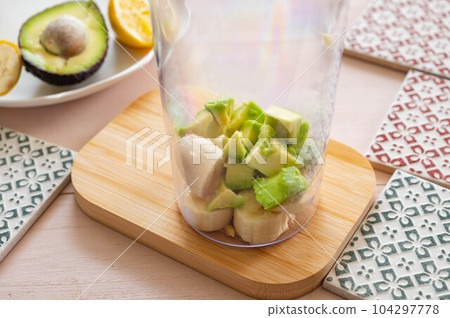 Making avocado and banana smoothie Making avocado and banana smoothie 104297778