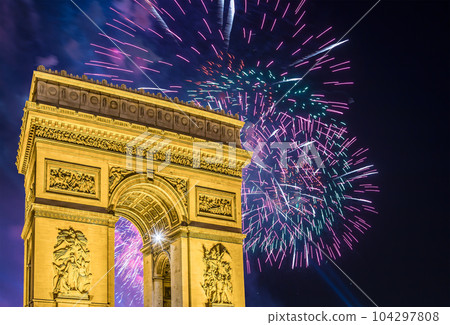 Celebratory colorful fireworks over the Arc de Triomphe, Paris, France. The walls of the arch are engraved with the names of 128 battles and names of 660 French military leaders (in French) Celebratory colorful fireworks over the Arc de Triomphe, Paris, France. The walls of the arch are engraved with the names of 128 battles and names of 660 French military leaders (in French) 104297808