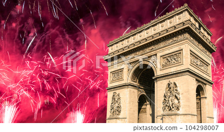 Celebratory colorful fireworks over the Arc de Triomphe, Paris, France 104298007