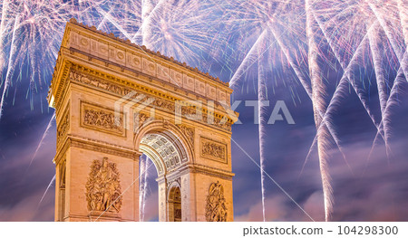 Celebratory colorful fireworks over the Arc de Triomphe, Paris, France. The walls of the arch are engraved with the names of 128 battles and names of 660 French military leaders (in French) 104298300