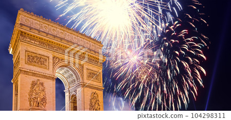 Celebratory colorful fireworks over the Arc de Triomphe, Paris, France. The walls of the arch are engraved with the names of 128 battles and names of 660 French military leaders (in French) 104298311