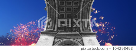 Celebratory colorful fireworks over the Arc de Triomphe, Paris, France. The walls of the arch are engraved with the names of 128 battles and names of 660 French military leaders (in French) 104298498