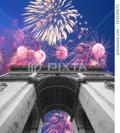 Celebratory colorful fireworks over the Arc de Triomphe, Paris, France 104298671