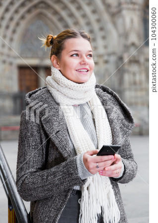 female in the historical center with mobile female in the historical center with mobile 104300060
