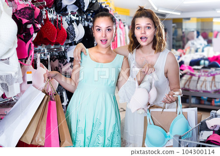 Cheerful girls are holding purchases 104300114
