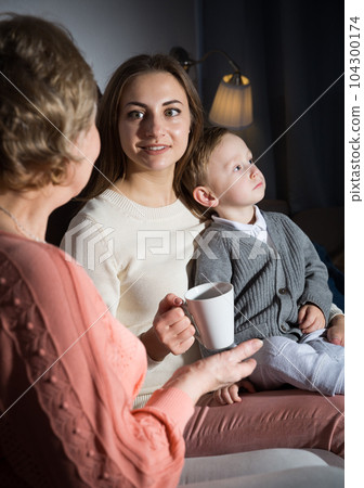 Adult female with her mother are talking about life and evening leisure 104300174