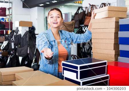 Girl and boxes with new pairs of shoes Girl and boxes with new pairs of shoes 104300203