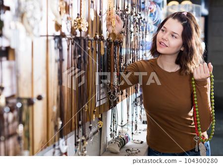 Woman showing different pendant 104300280