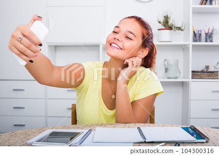 girl doing selfie during studying . 104300316