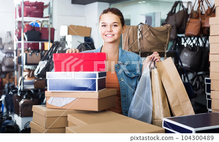 portrait of teenage girl standing with bags in store with bags portrait of teenage girl standing with bags in store with bags 104300489
