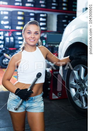 Mechanic working on car wheel Mechanic working on car wheel 104300601