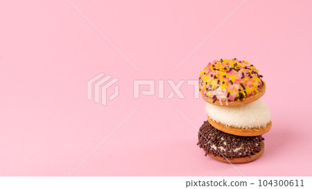 Cakes with decoration for confectionery - pink background with sweets, space for text Cakes with decoration for confectionery - pink background with sweets, space for text 104300611