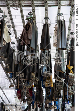 Scenic bottom view old abandoned coal mine worker clothing dressing room hanged at ceiling with chain lockers. Historical industrial mining museum Goslar tour. Industry decay recession concept 104300715