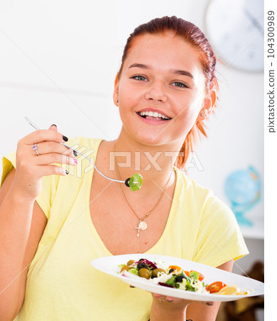 teenager eating salad 104300989