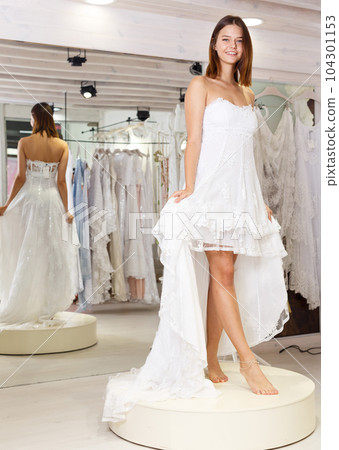 Girl fitting wedding dress 104301153