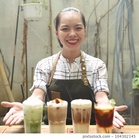 Asian woman waitress prepared beverages to serve in a coffee shop Asian woman waitress prepared beverages to serve in a coffee shop 104302145