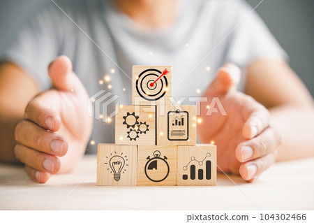 Hand arranging wood blocks in a step-by-step formation, symbolizing business strategy and Action plan. Copy space provided for professional presentations. Hand arranging wood blocks in a step-by-step formation, symbolizing business strategy and Action plan. Copy space provided for professional presentations. 104302466