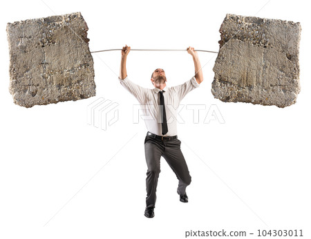 Powerful and determined businessman trains with a barbell with stones 104303011